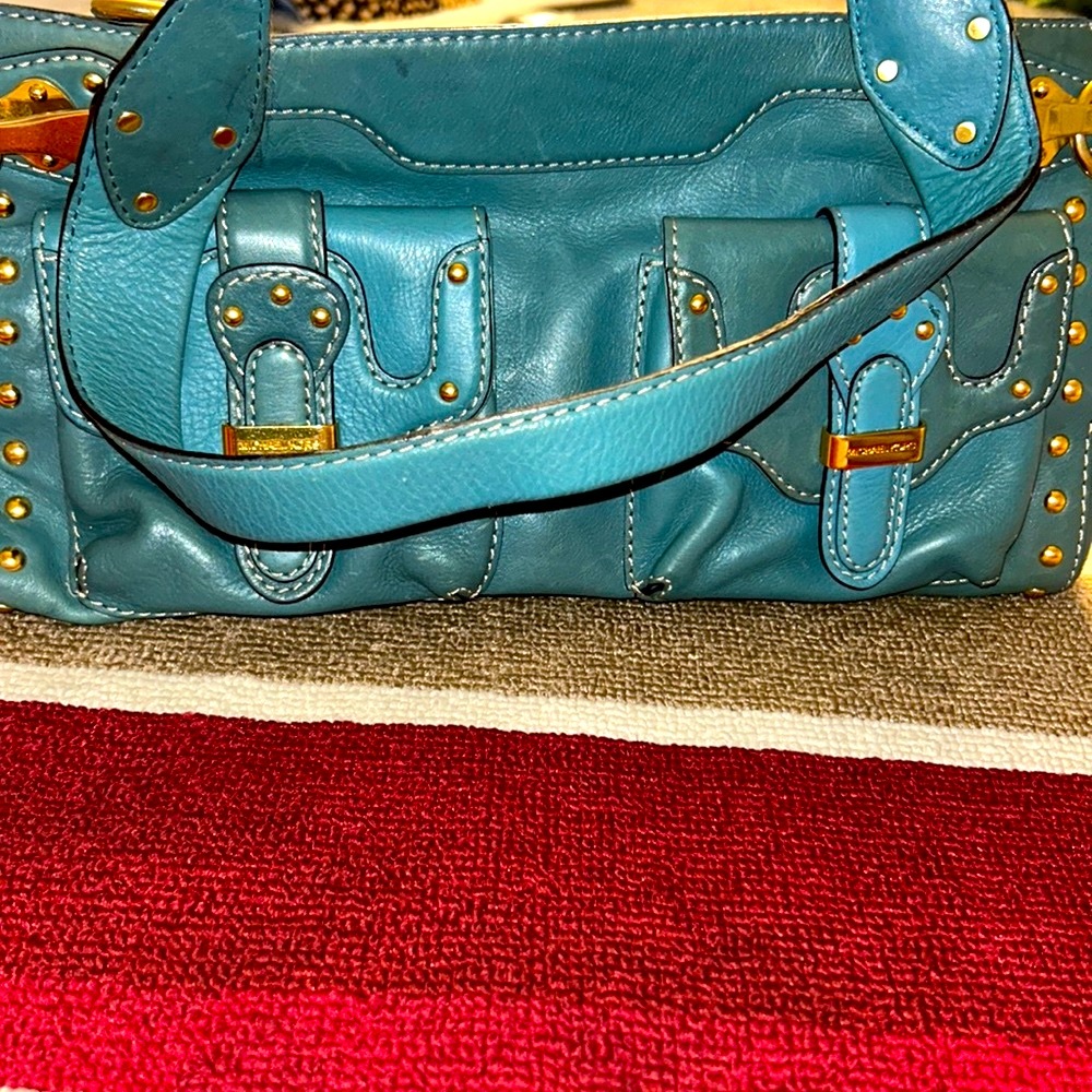 gold plated Michael Kors handbag inside zipper pockets outside buckle pockets